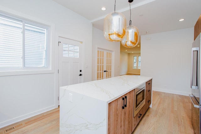 3621 N Richmond St, Chicago, IL 60618 - kitchen featuring pendant lighting, light stone countertops, light wood-type flooring, recessed lighting, and appliances with stainless steel finishes