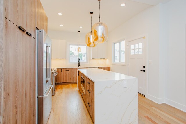 3621 N Richmond St, Chicago, IL 60618 - kitchen with stainless steel appliances, recessed lighting, light wood-type flooring, and a center island
