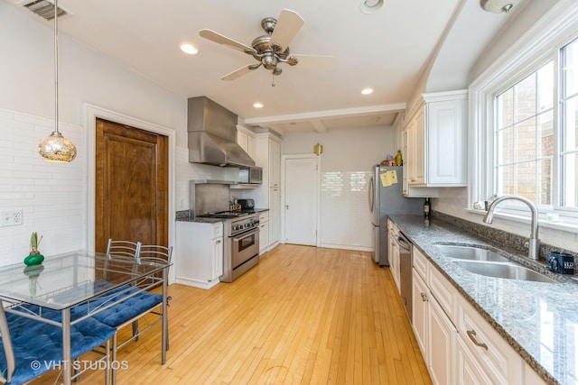 130 Le Moyne Pkwy, Oak Park, IL 60302 - kitchen with wall chimney exhaust hood, a sink, stainless steel appliances, ceiling fan, and stone counters