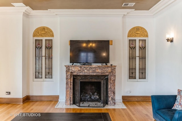 130 Le Moyne Pkwy, Oak Park, IL 60302 - living area with wood finished floors, crown molding, baseboards, and a fireplace