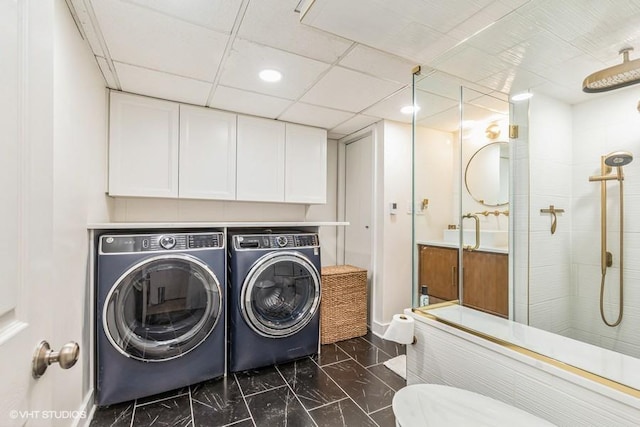 laundry room with marble finish floor, laundry area, washing machine and clothes dryer, and baseboards