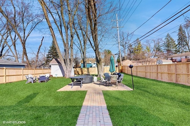 view of yard featuring a patio area, a fire pit, and a fenced backyard