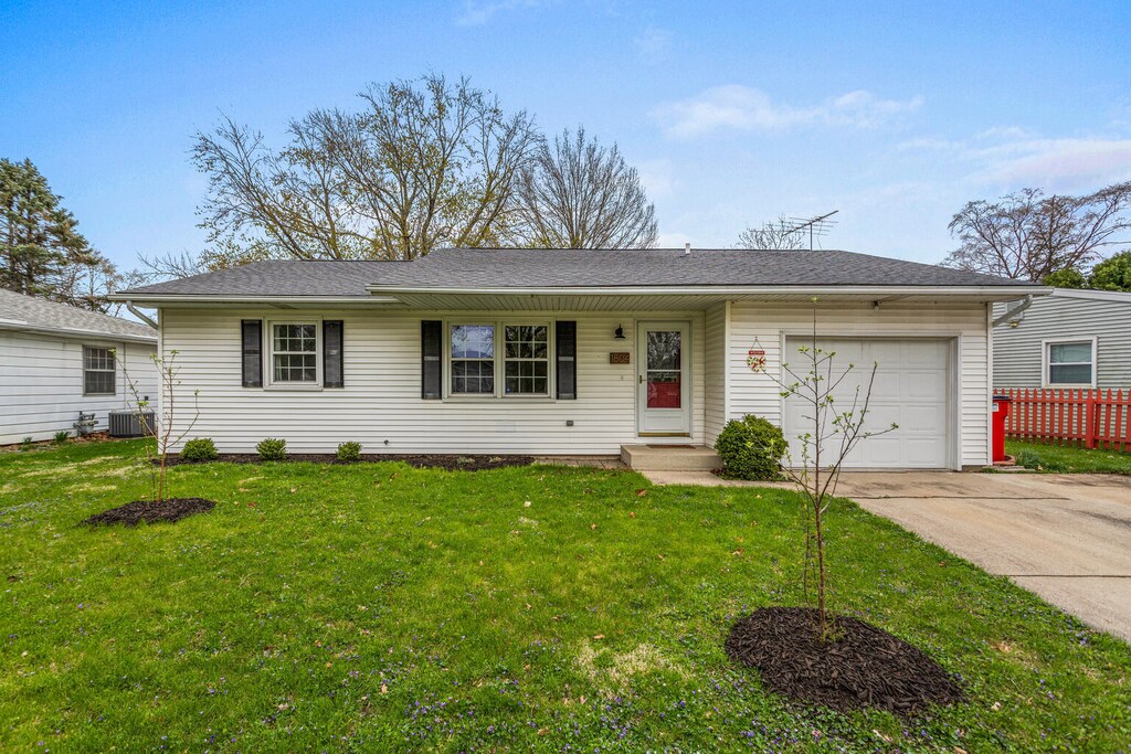 1804 Scottsdale Dr, Champaign, IL 61821 - ranch-style home featuring a garage, central air condition unit, a front yard, and concrete driveway