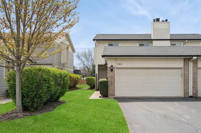 745 Grouse Ct, Deerfield, IL 60015 - view of side of home with brick siding, a shingled roof, a lawn, and aphalt driveway