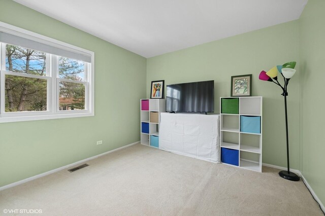 interior space with baseboards, visible vents, and carpet