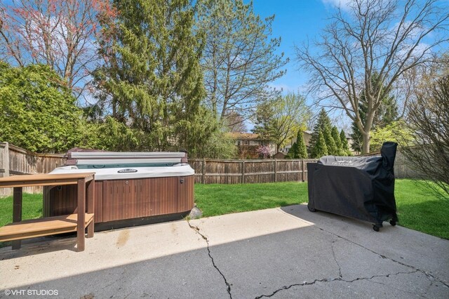 view of patio / terrace with a hot tub and a fenced backyard