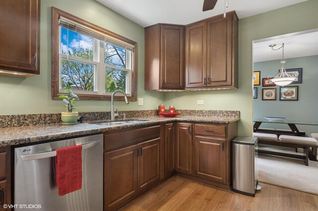 kitchen featuring dishwasher, a ceiling fan, light wood-style flooring, and a sink