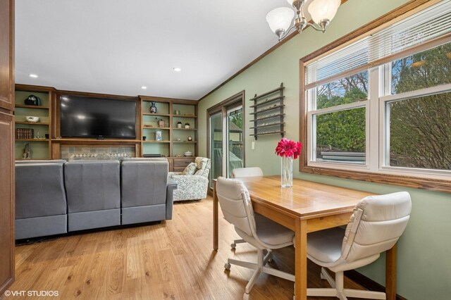 dining space with light wood-style flooring, recessed lighting, and a notable chandelier