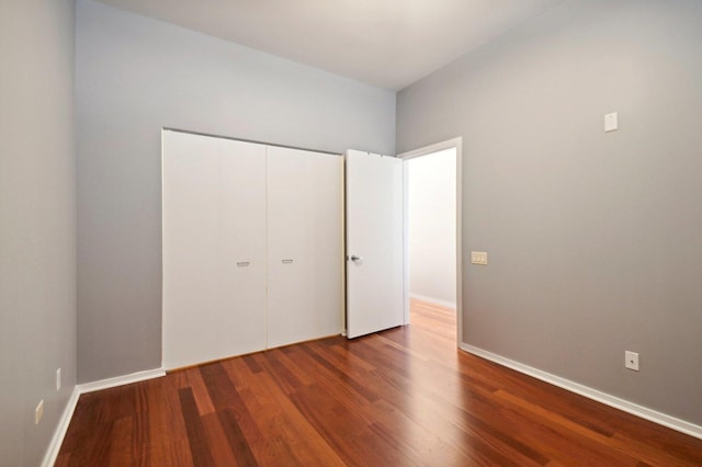 65 E Monroe St Unit 4521, Chicago, IL 60603 - unfurnished bedroom featuring dark wood-type flooring, a closet, and baseboards