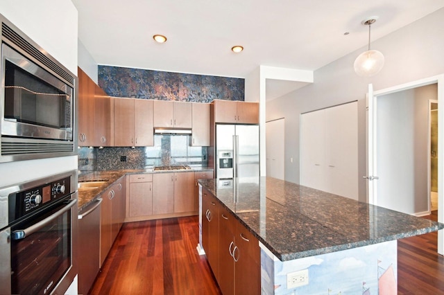 65 E Monroe St Unit 4521, Chicago, IL 60603 - kitchen with dark stone counters, a kitchen island, stainless steel appliances, decorative backsplash, and dark wood-style floors