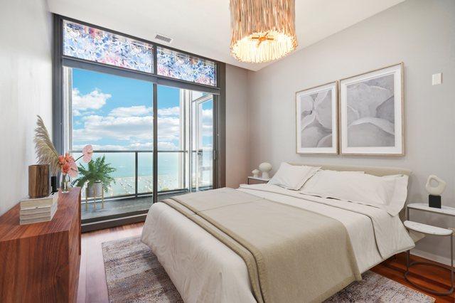 65 E Monroe St Unit 4521, Chicago, IL 60603 - bedroom featuring floor to ceiling windows, visible vents, an inviting chandelier, and wood finished floors