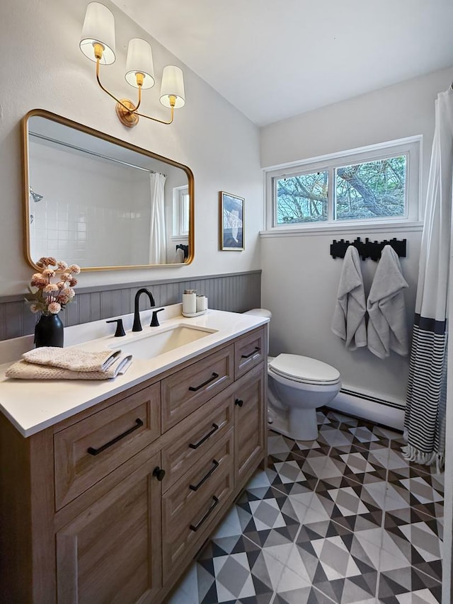 124 N Whistler Ave Unit B8, Freeport, IL 61032 - full bathroom featuring vanity, tile patterned floors, toilet, a wainscoted wall, and a baseboard radiator
