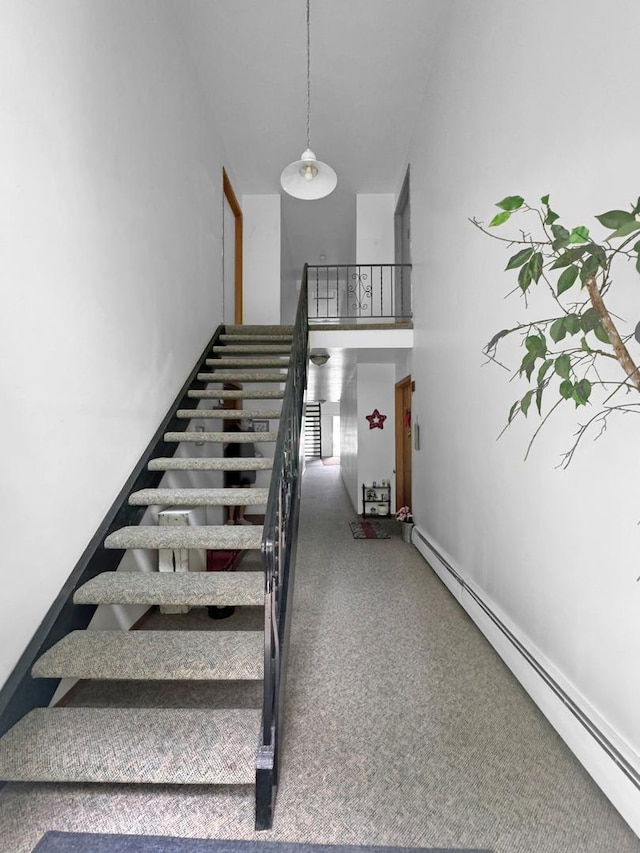 124 N Whistler Ave Unit B8, Freeport, IL 61032 - staircase featuring carpet, a towering ceiling, and a baseboard heating unit