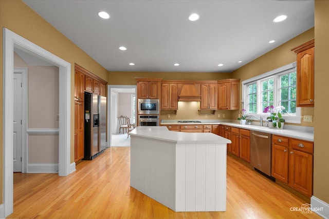 40W065 Fox Mill Blvd, Saint Charles, IL 60175 - kitchen with stainless steel appliances, light countertops, a center island, light wood-type flooring, and recessed lighting