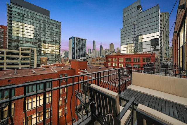 balcony at dusk with a view of city