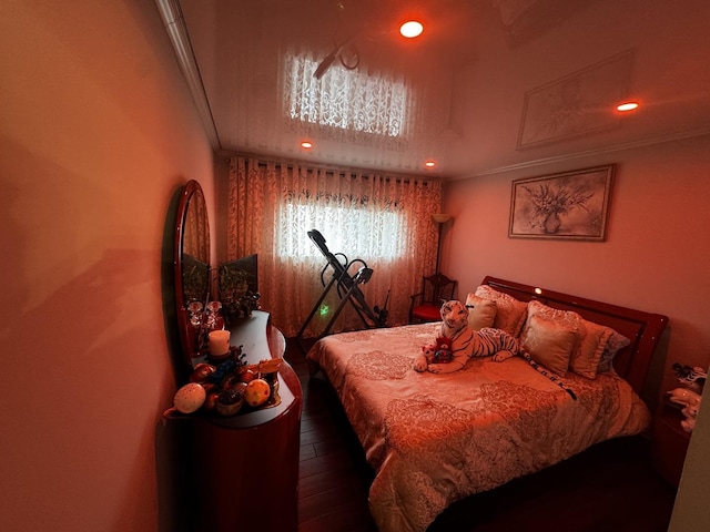 bedroom with crown molding, wood finished floors, and recessed lighting