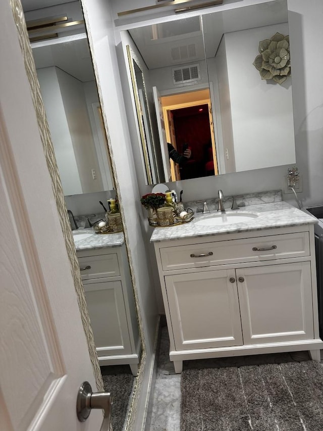 bathroom featuring vanity and visible vents