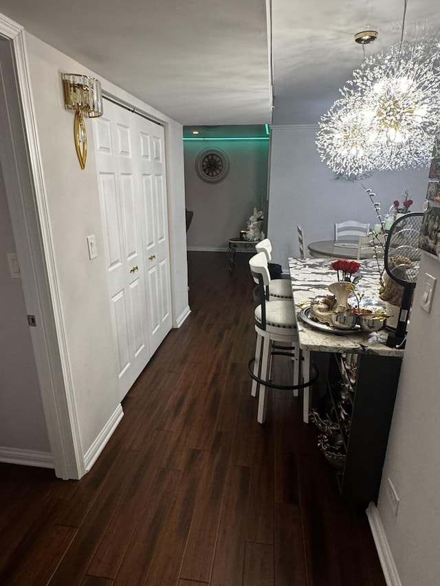 dining room with dark wood-style floors and baseboards