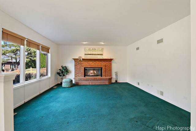 unfurnished living room with visible vents, a brick fireplace, and carpet floors