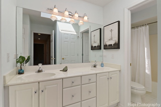 full bath featuring toilet, tile patterned floors, double vanity, and a sink