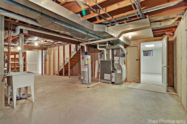 unfinished below grade area featuring stairs, water heater, and heating unit