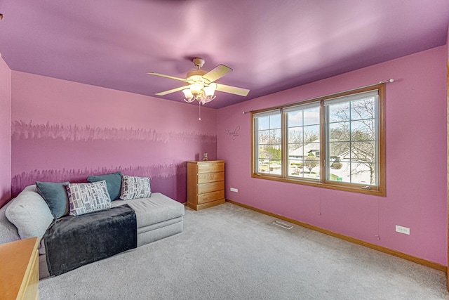 sitting room with carpet flooring, visible vents, baseboards, and ceiling fan