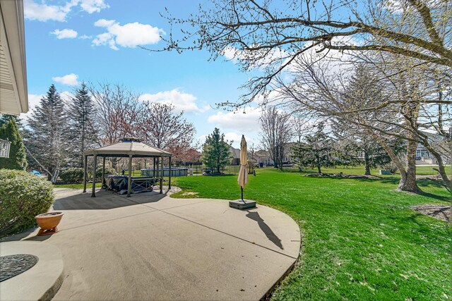 exterior space with a gazebo, a patio area, and a lawn