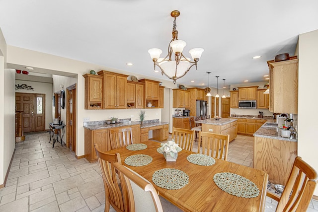 dining room featuring recessed lighting, a notable chandelier, baseboards, and stone tile floors