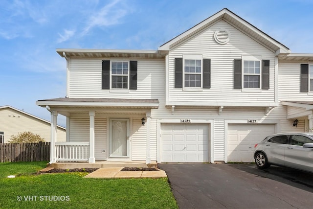 view of front of home featuring fence, a front lawn, an attached garage, driveway, and covered porch