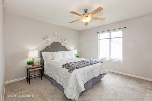 bedroom featuring ceiling fan, baseboards, and light colored carpet