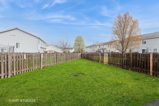 view of yard with a residential view and a fenced backyard