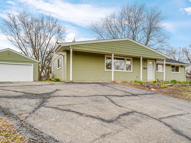 view of front facade featuring a garage and an outdoor structure