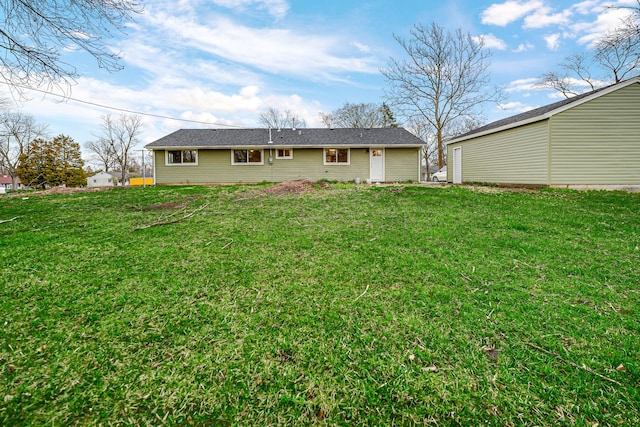 rear view of property with a lawn
