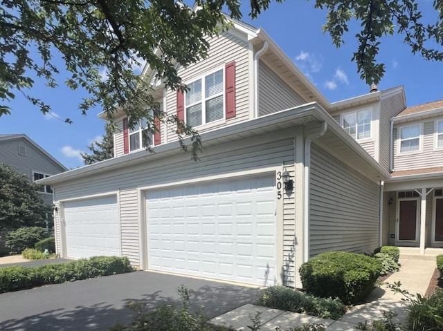 305 Fairmont Ct Unit 305, Saint Charles, IL 60175 - view of side of home featuring an attached garage and driveway