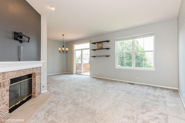 305 Fairmont Ct Unit 305, Saint Charles, IL 60175 - unfurnished living room featuring a fireplace, a chandelier, and carpet flooring