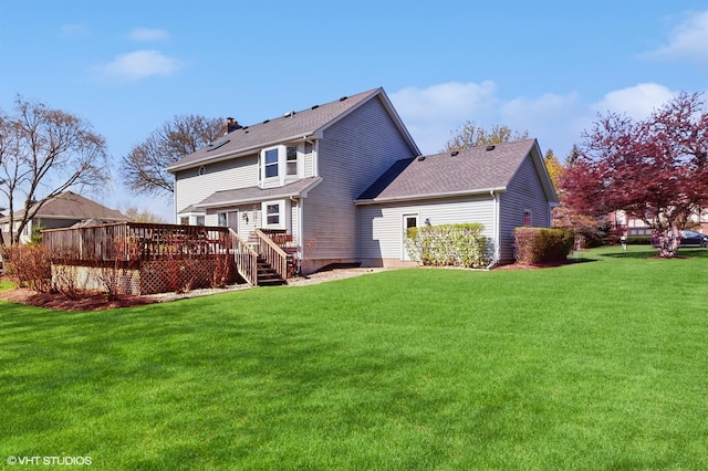 back of property featuring a wooden deck and a yard