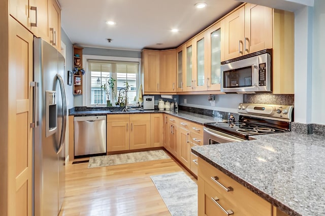 2609 Eisenhower Dr, Des Plaines, IL 60018 - kitchen featuring stainless steel appliances, light wood-type flooring, dark stone counters, light brown cabinetry, and recessed lighting