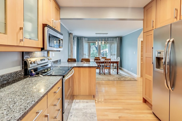 2609 Eisenhower Dr, Des Plaines, IL 60018 - kitchen featuring stainless steel appliances, light wood-style flooring, stone countertops, glass insert cabinets, and a peninsula