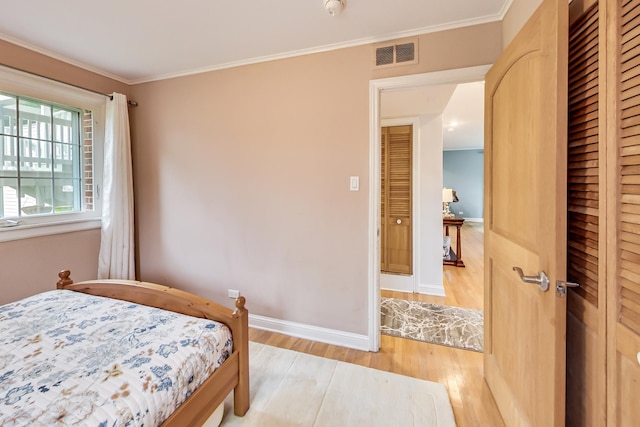 2609 Eisenhower Dr, Des Plaines, IL 60018 - bedroom featuring wood finished floors, a closet, and crown molding