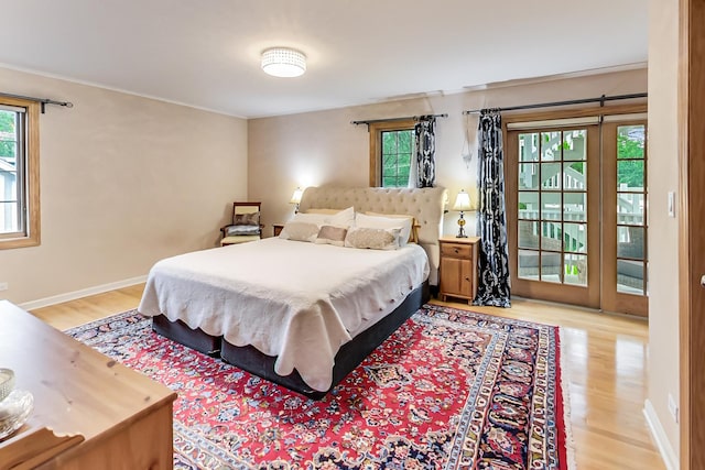 2609 Eisenhower Dr, Des Plaines, IL 60018 - bedroom featuring light wood-type flooring, multiple windows, access to outside, and ornamental molding