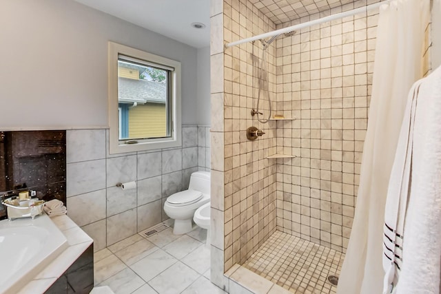 2609 Eisenhower Dr, Des Plaines, IL 60018 - bathroom featuring tile walls, a stall shower, a bidet, and tile patterned floors