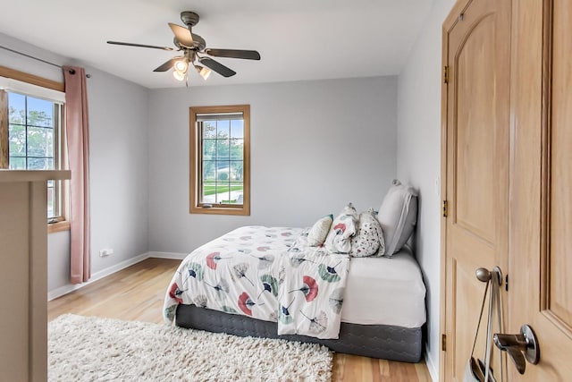2609 Eisenhower Dr, Des Plaines, IL 60018 - bedroom featuring multiple windows, light wood-style flooring, and ceiling fan