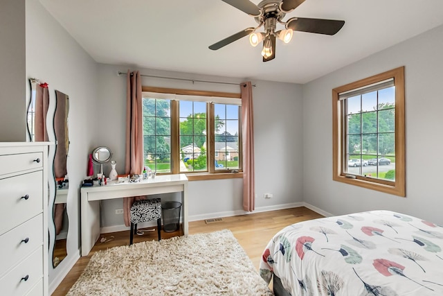2609 Eisenhower Dr, Des Plaines, IL 60018 - bedroom with multiple windows, light wood-type flooring, an office area, and ceiling fan