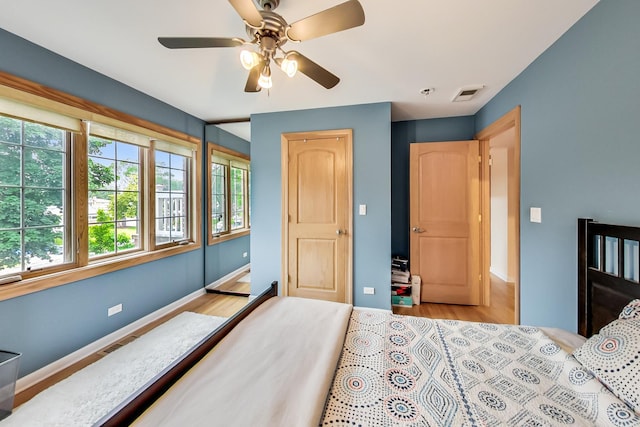 2609 Eisenhower Dr, Des Plaines, IL 60018 - bedroom featuring multiple windows, light wood finished floors, and ceiling fan