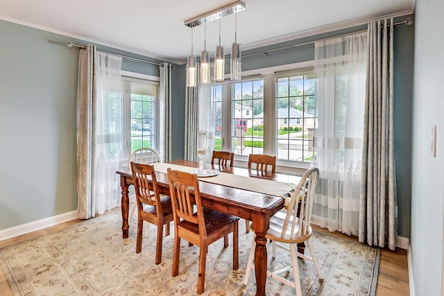 2609 Eisenhower Dr, Des Plaines, IL 60018 - dining room featuring crown molding, healthy amount of natural light, and light wood-type flooring