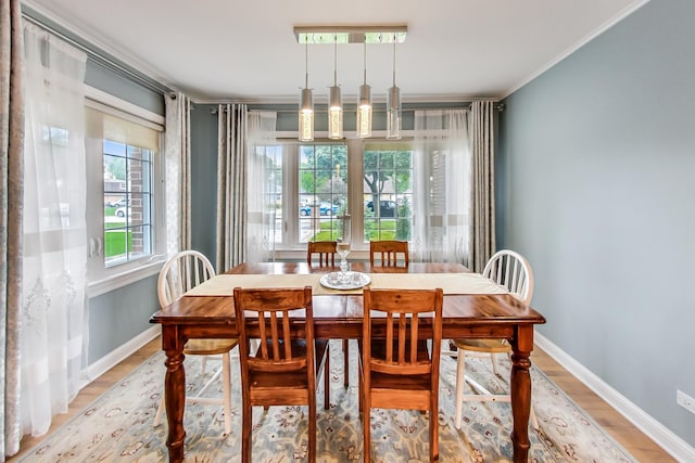 2609 Eisenhower Dr, Des Plaines, IL 60018 - dining room featuring light wood finished floors and ornamental molding