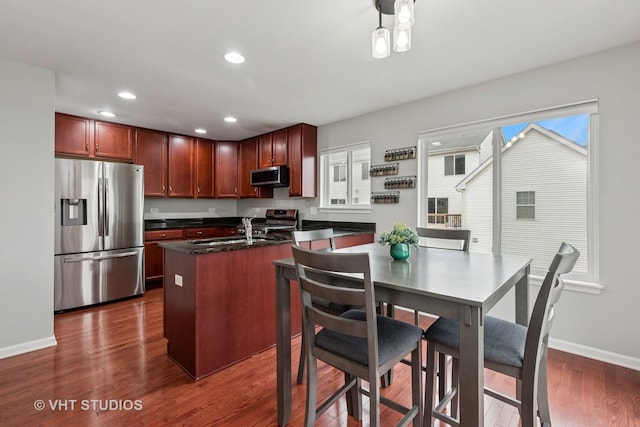 kitchen featuring dark wood-type flooring, recessed lighting, a sink, stainless steel appliances, and baseboards
