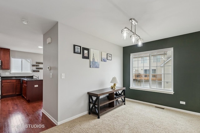dining area featuring visible vents, baseboards, and dark wood finished floors
