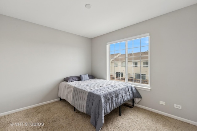 bedroom with baseboards and carpet floors