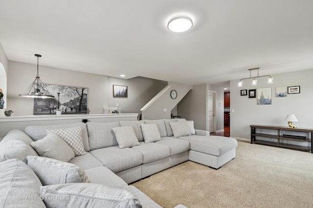 carpeted living area with baseboards